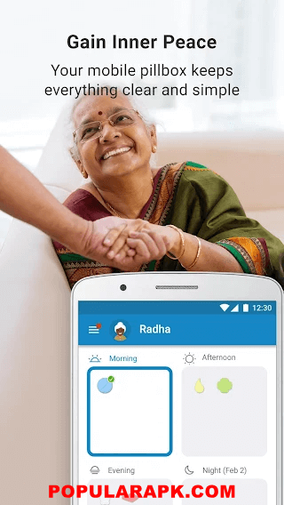 old lady holding hands with medisafe app on phone.