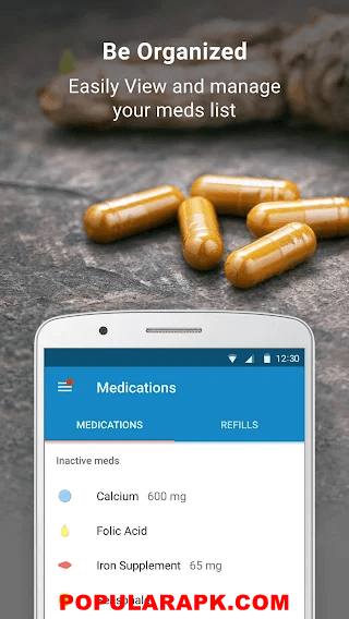 yellow pills on surface with app installed on phone.